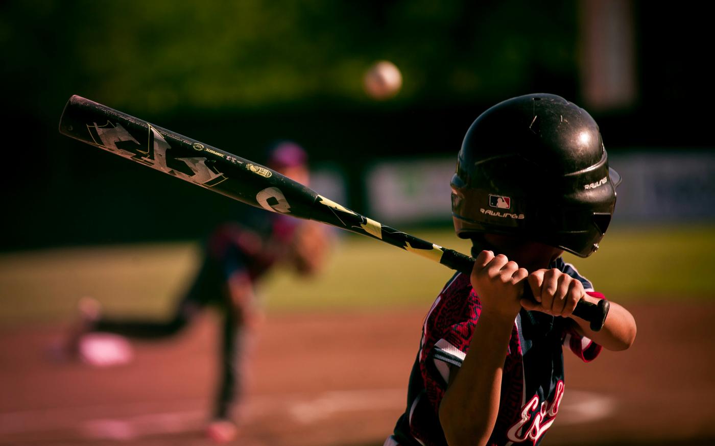 selective focus photography of person holding baseball bat by Eduardo Balderas courtesy of Unsplash.