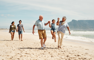 Retirement Grandparents with Grandchild on Beach