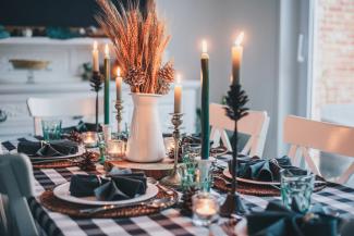 white candles on round table by Libby Penner courtesy of Unsplash.