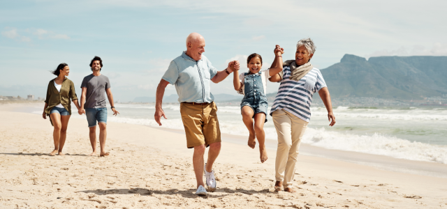 Retirement Grandparents with Grandchild on Beach