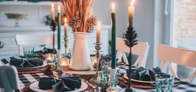 white candles on round table by Libby Penner courtesy of Unsplash.