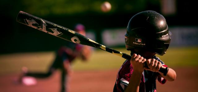 selective focus photography of person holding baseball bat by Eduardo Balderas courtesy of Unsplash.
